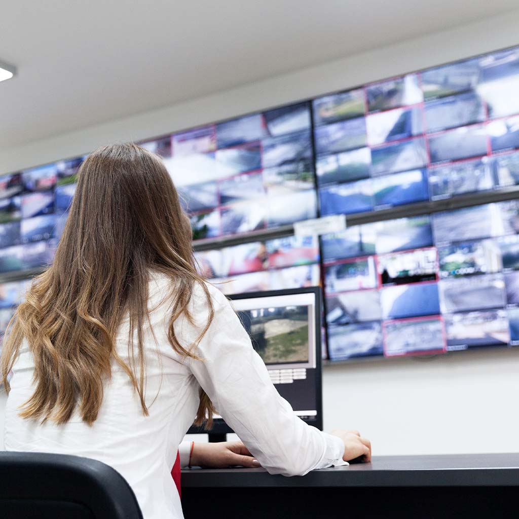 Airport Security Room with operator looking at monitor wall