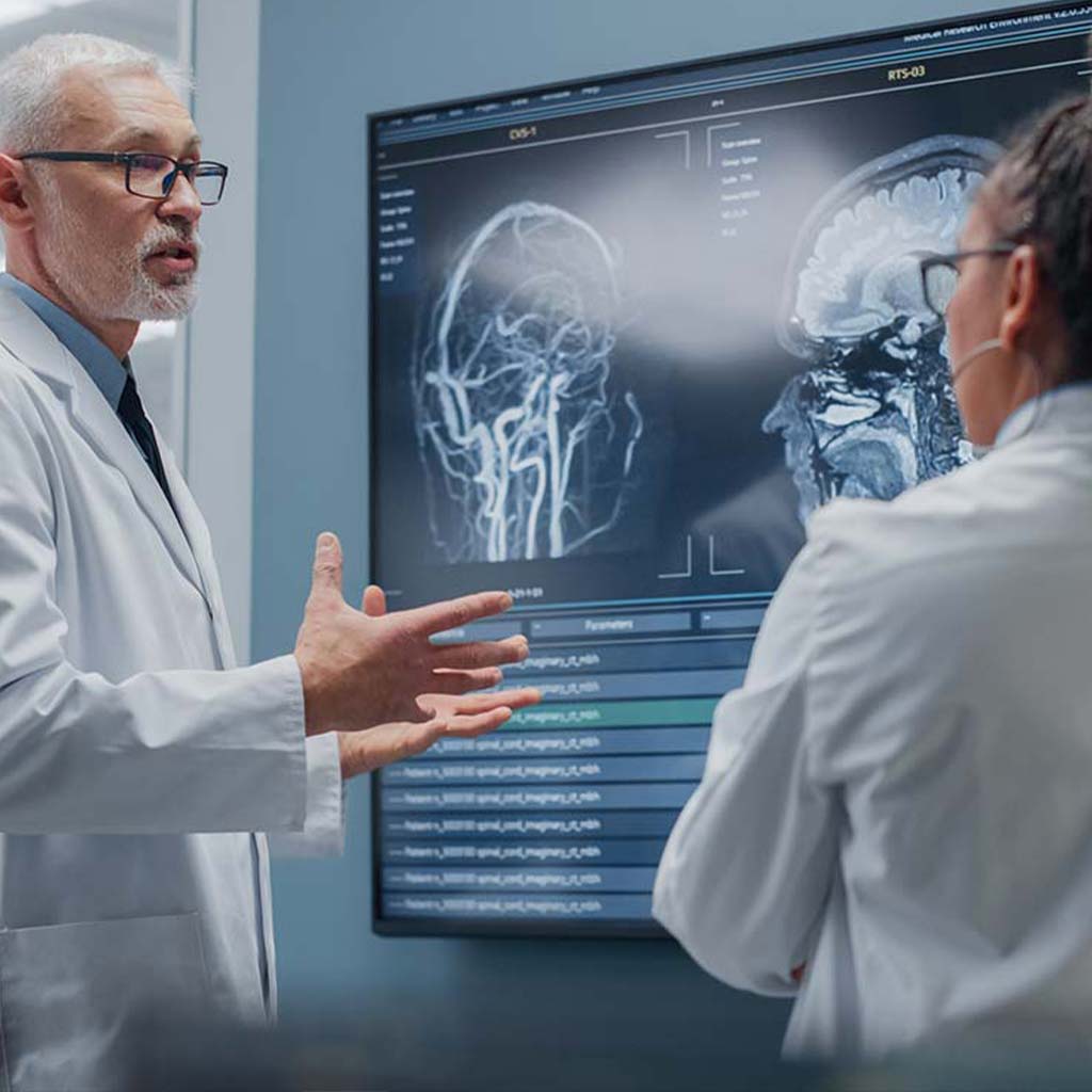 healthcare professionals analyzing x-ray scans on av wall in clinic