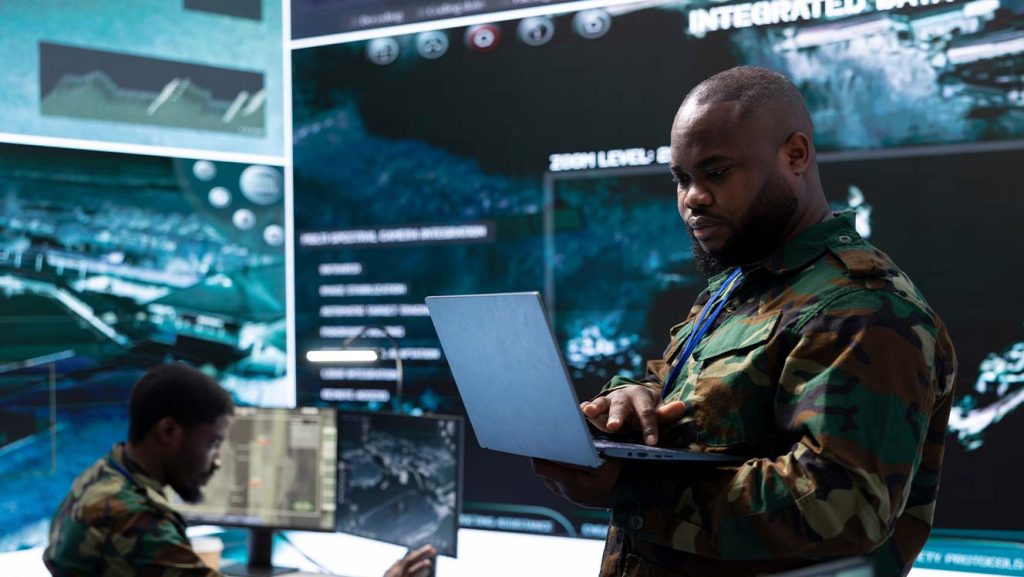 military commander in control room surrounded by video walls