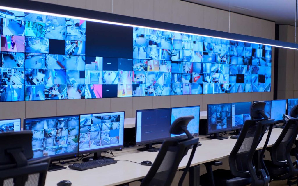control room with large AV video wall system and console furniture workstations